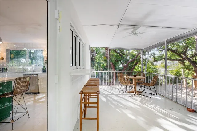 a view of a porch with furniture and a yard