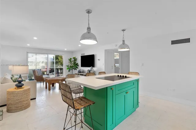 a view of a dining room and livingroom with furniture wooden floor a chandelier