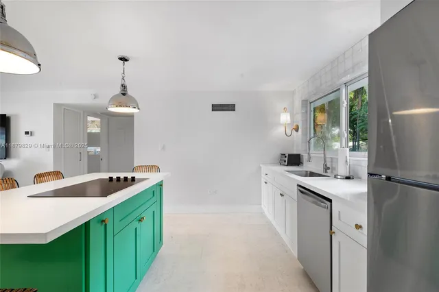 a kitchen with a sink stove and refrigerator