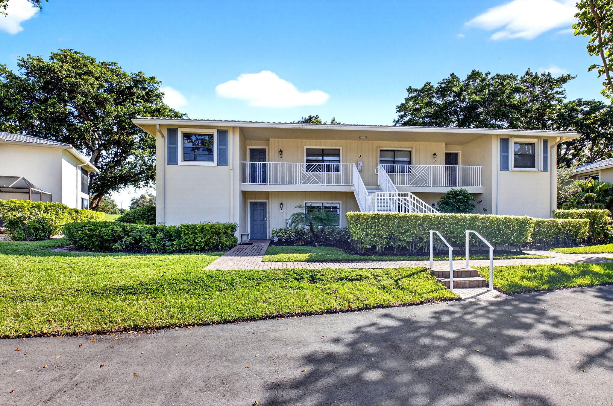 3 Westgate Lane, Unit C Boynton Beach, FL 33436 - Photo 16 of 98 a front view of a house with a yard and garage