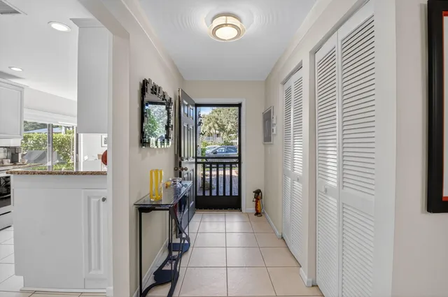 a kitchen with granite countertop white cabinets stainless steel appliances and a sink