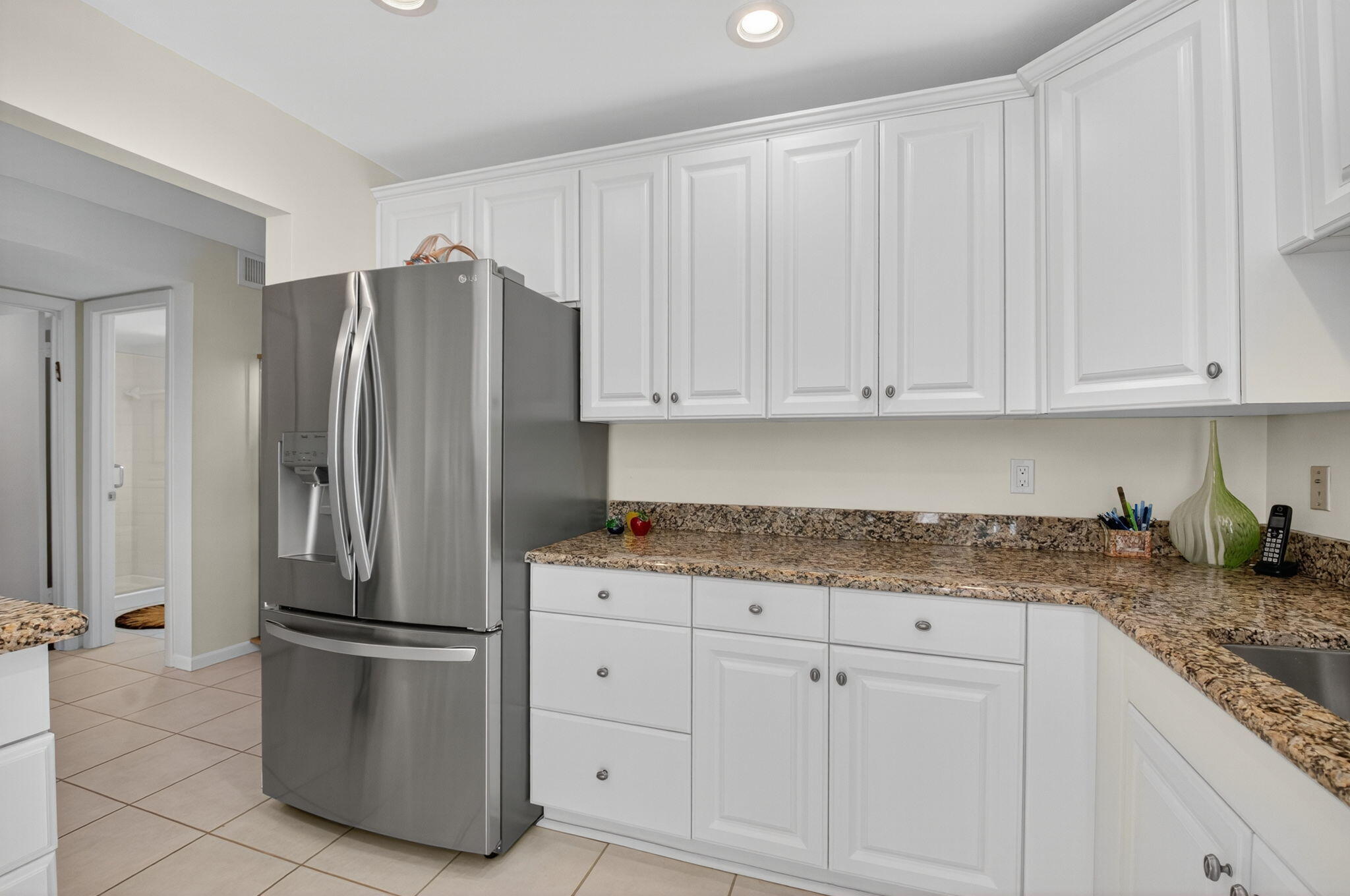 3 Westgate Lane, Unit C Boynton Beach, FL 33436 - Photo 31 of 98 a kitchen with stainless steel appliances granite countertop a refrigerator sink and cabinets