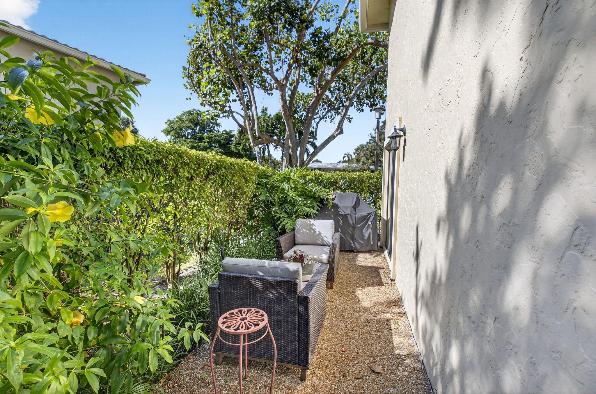 3 Westgate Lane, Unit C Boynton Beach, FL 33436 - Photo 40 of 98 a backyard of a house with fountain table and chairs