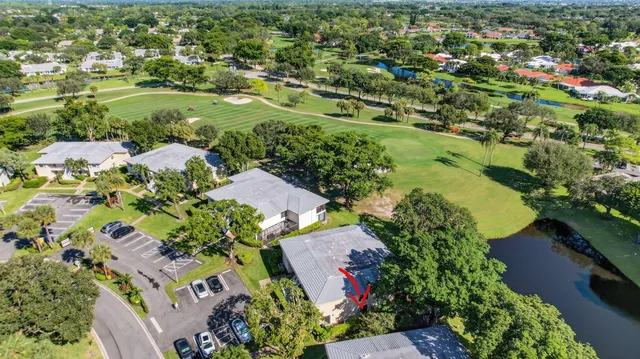 an aerial view of residential houses with outdoor space and trees