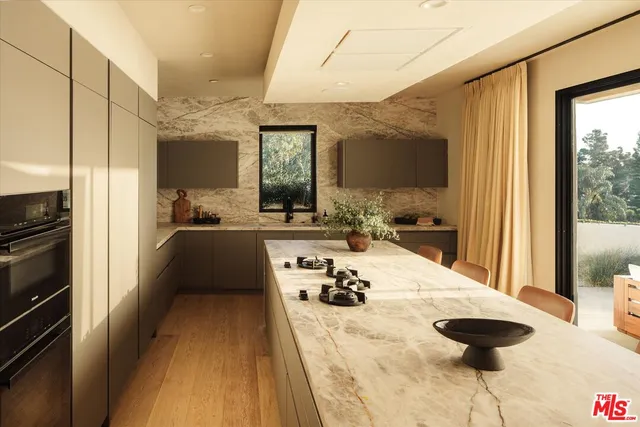 a large bedroom with a large bed and a chandelier