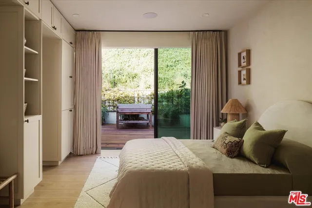 a bedroom with a bed and a large window