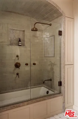 a bathroom with a bathtub and a shower