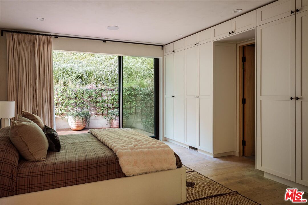 1820 Rising Glen Road Los Angeles, CA 90069 - Photo 16 of 30 a bedroom with a bed couch and window