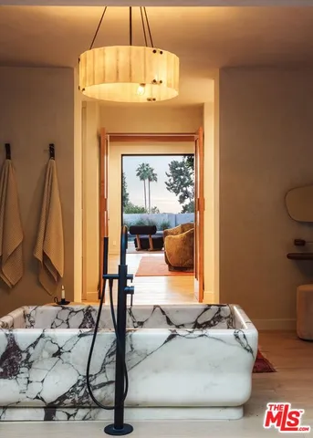 a living room with furniture and a mirror