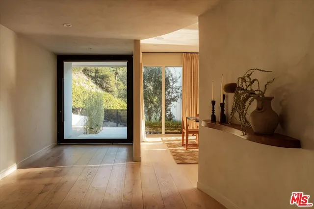 a view of a room with wooden floor and furniture
