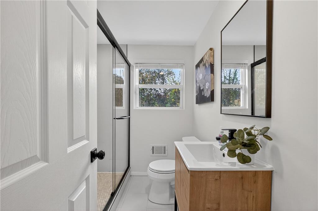 2967 Flat Shoals Road Decatur, GA 30034 - Photo 21 of 37 a bathroom with a toilet a sink and a mirror