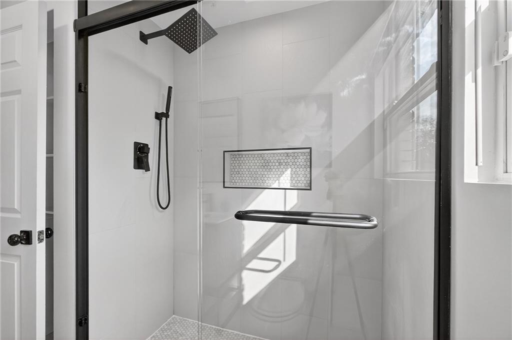 2967 Flat Shoals Road Decatur, GA 30034 - Photo 23 of 37 a bathroom with a shower and a mirror