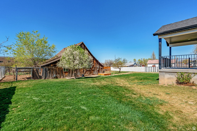 75 North 100th Street West Fillmore, UT 84631 - Photo 50 of 62 Fenced backyard featuring an outbuilding and a barn