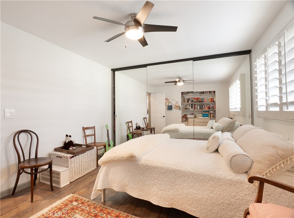 419 Gloucester Drive Costa Mesa, CA 92627 - Photo 14 of 51 a bedroom with a bed a couch and a chandelier