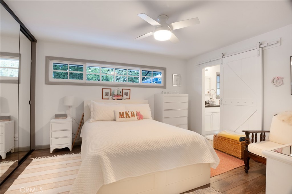 419 Gloucester Drive Costa Mesa, CA 92627 - Photo 15 of 51 a bedroom with a bed a mirror and lamp