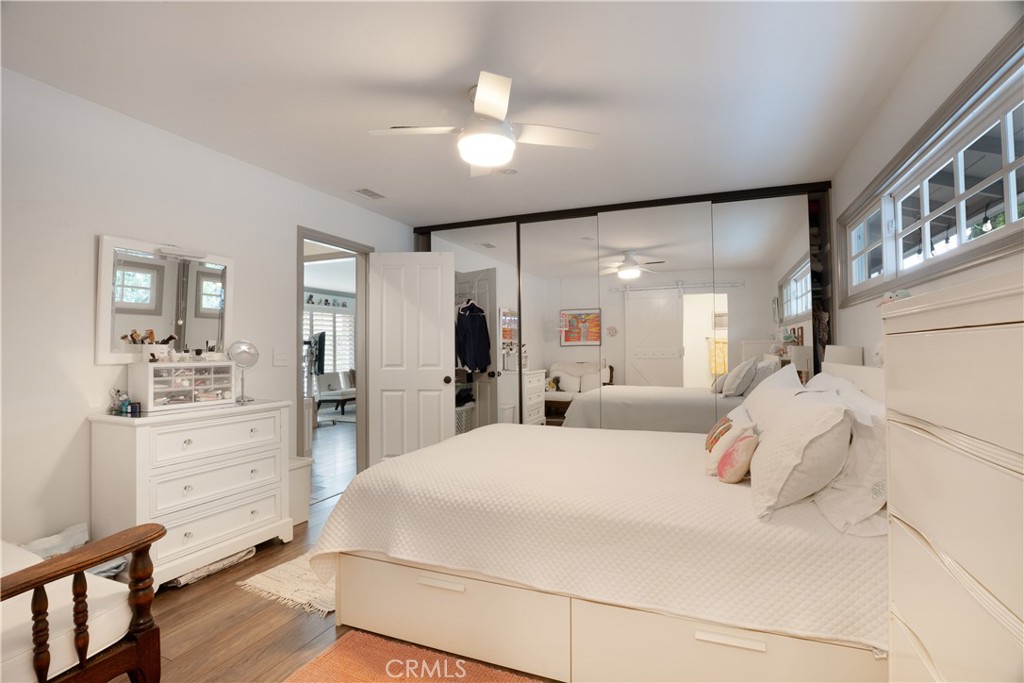 419 Gloucester Drive Costa Mesa, CA 92627 - Photo 19 of 51 a bedroom with a large bed and a chandelier