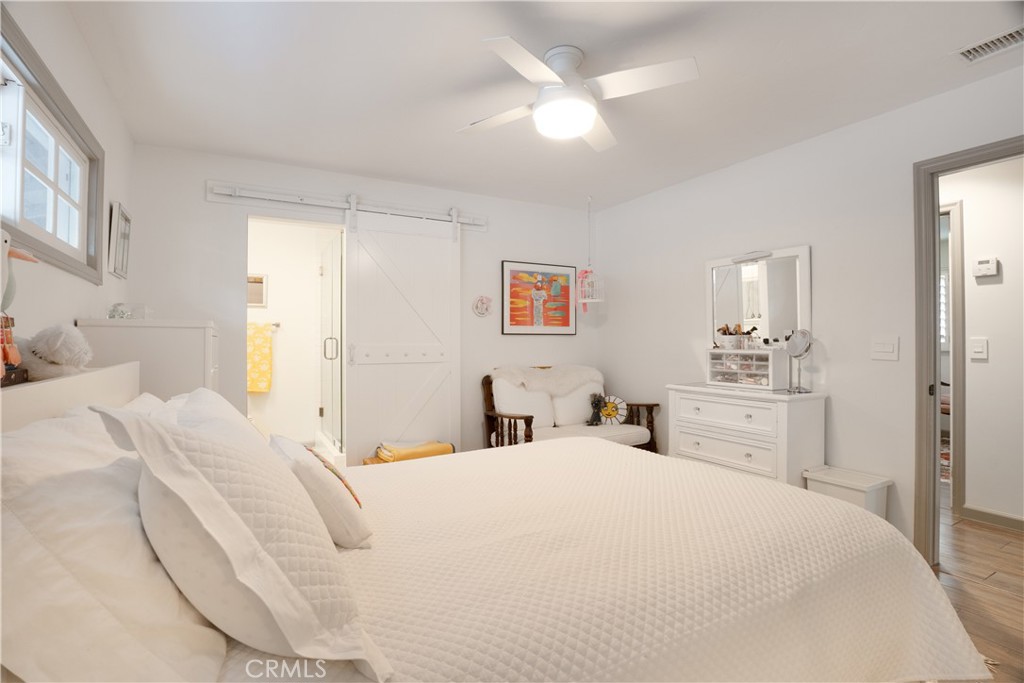 419 Gloucester Drive Costa Mesa, CA 92627 - Photo 20 of 51 a bedroom with a bed and a chandelier