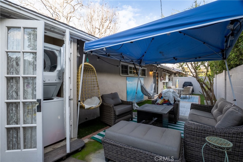 419 Gloucester Drive Costa Mesa, CA 92627 - Photo 26 of 51 a view of a patio with couches chairs and a table and chairs