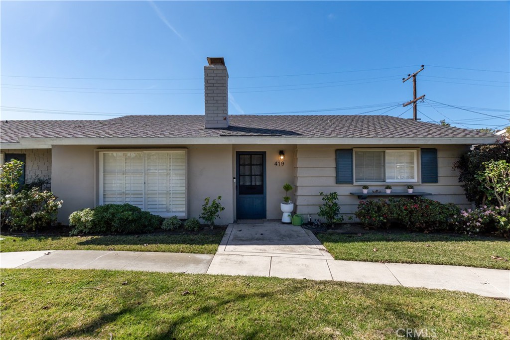 419 Gloucester Drive Costa Mesa, CA 92627 - Photo 43 of 51 a front view of a house with garden