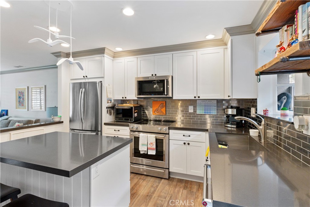 419 Gloucester Drive Costa Mesa, CA 92627 - Photo 9 of 51 a kitchen with stainless steel appliances granite countertop a sink stove and refrigerator