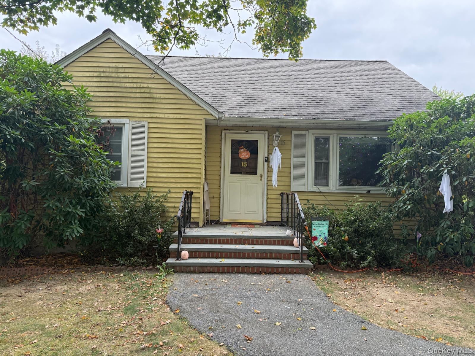 View of front of home with a shingled roof