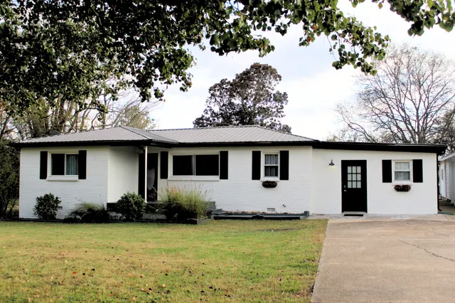 a house that has a tree in front of it