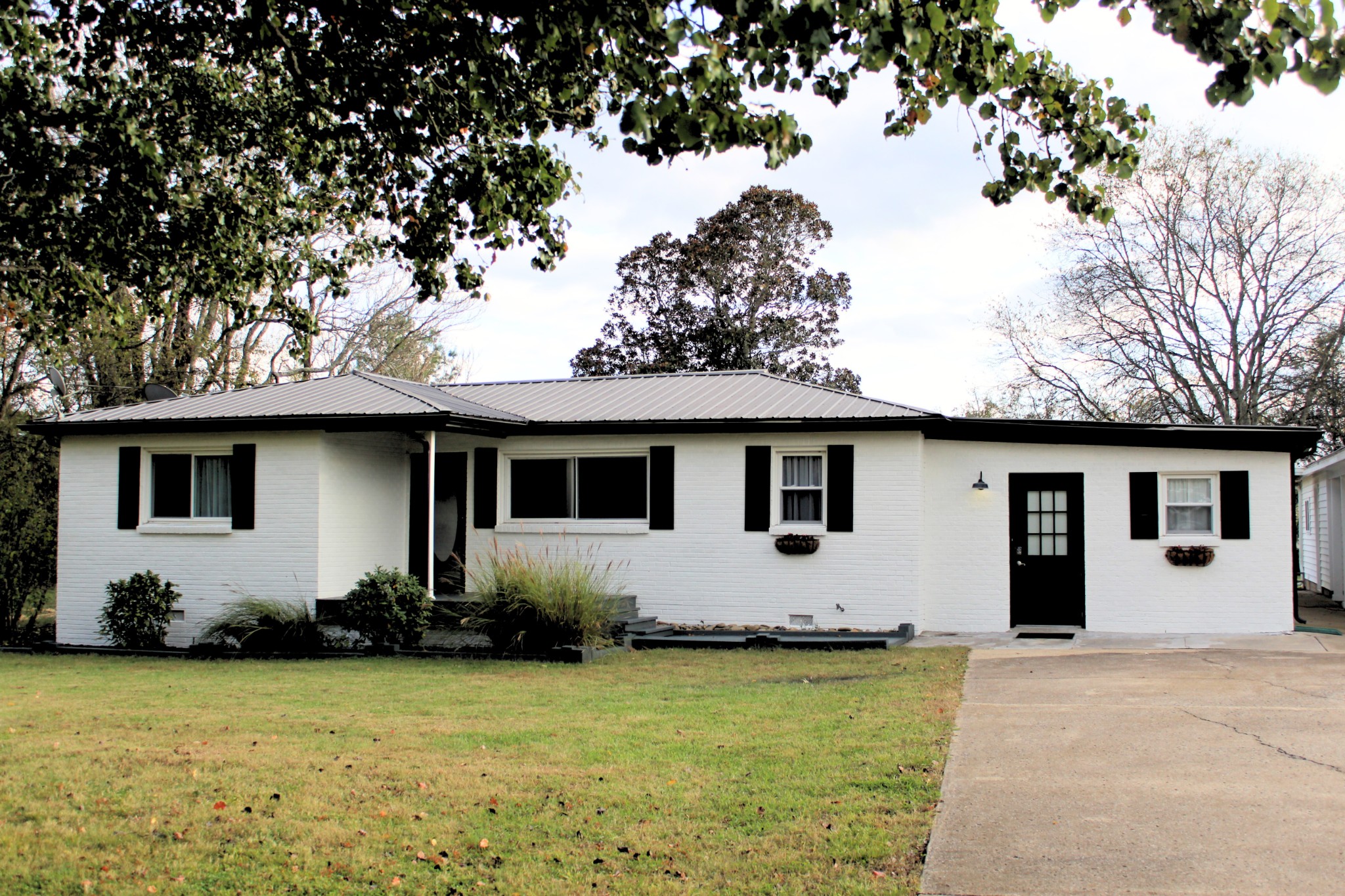 a house that has a tree in front of it