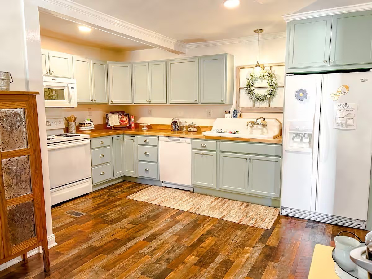 701 Morton Road Murfreesboro, TN 37128 - Photo 5 of 24 a kitchen with stainless steel appliances granite countertop a refrigerator a sink dishwasher and white cabinets with wooden floor