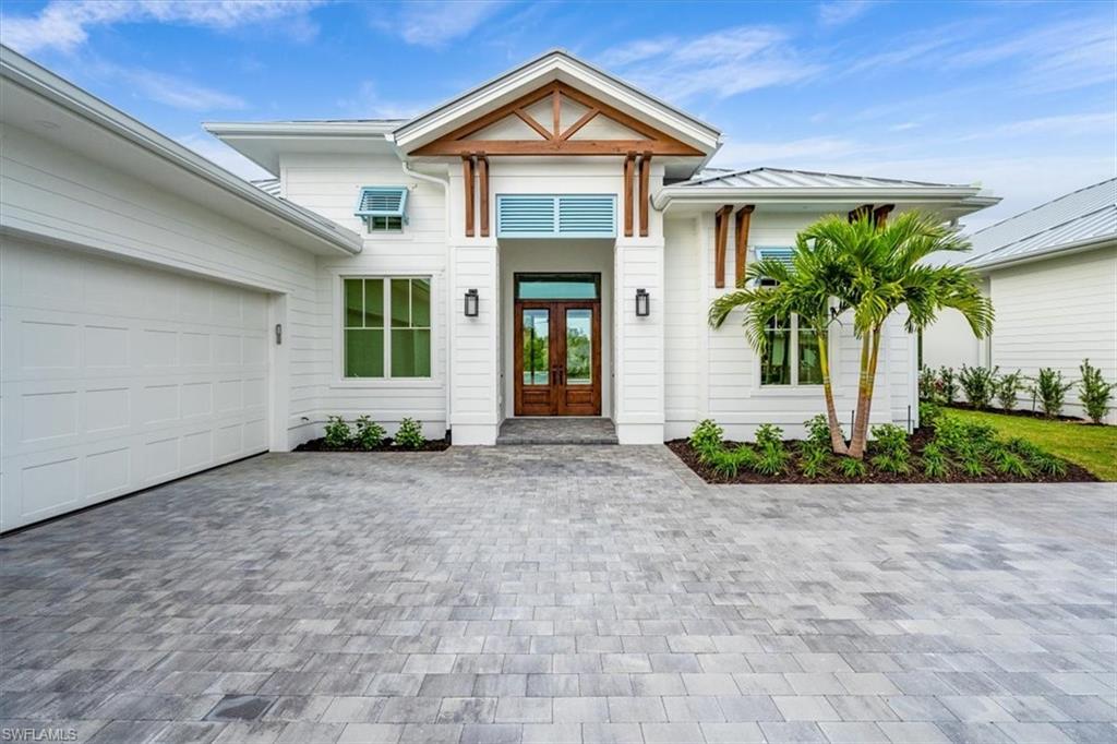 Coconut Landing homes feature a coastal contemporary vibe, with standing seam metal roofing, colorful bahama shutters, and decorative wood accents.