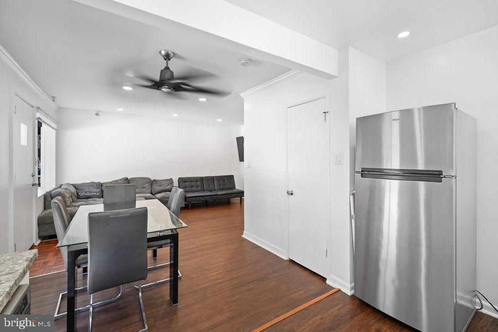 2010 Ray Leonard Road Landover, MD 20785 - Photo 11 of 43 a view of a kitchen with dining area a refrigerator wooden floor and a ceiling fan