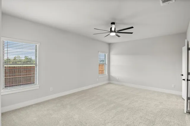 a view of room with a ceiling fan and window