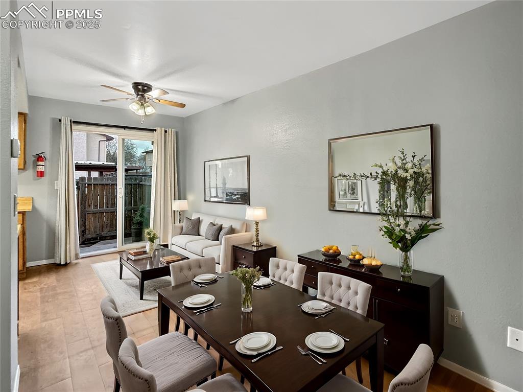 3033 Starlight Circle Colorado Springs, CO 80916 - Photo 11 of 44 a view of a dining room with furniture and wooden floor