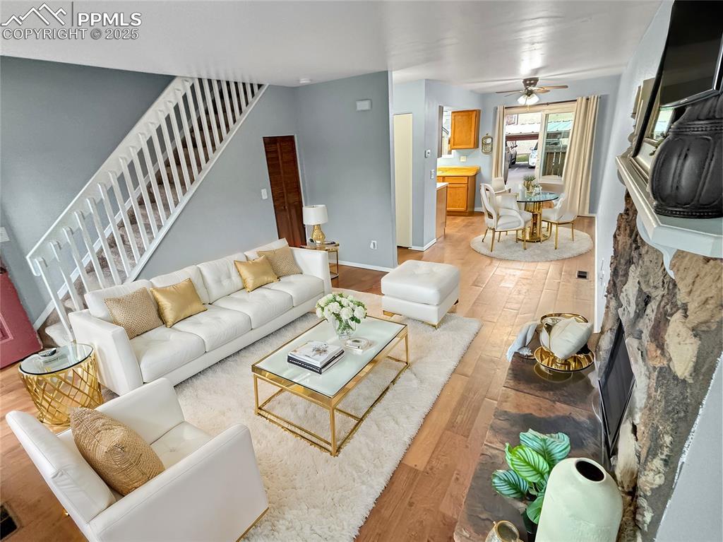 3033 Starlight Circle Colorado Springs, CO 80916 - Photo 16 of 44 a living room with furniture fireplace and a flat screen tv