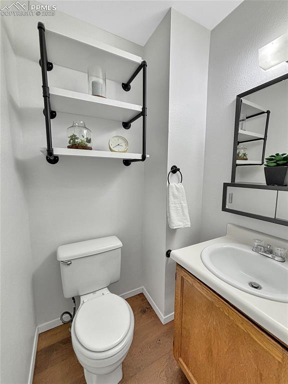3033 Starlight Circle Colorado Springs, CO 80916 - Photo 18 of 44 a bathroom with a sink a toilet and a mirror