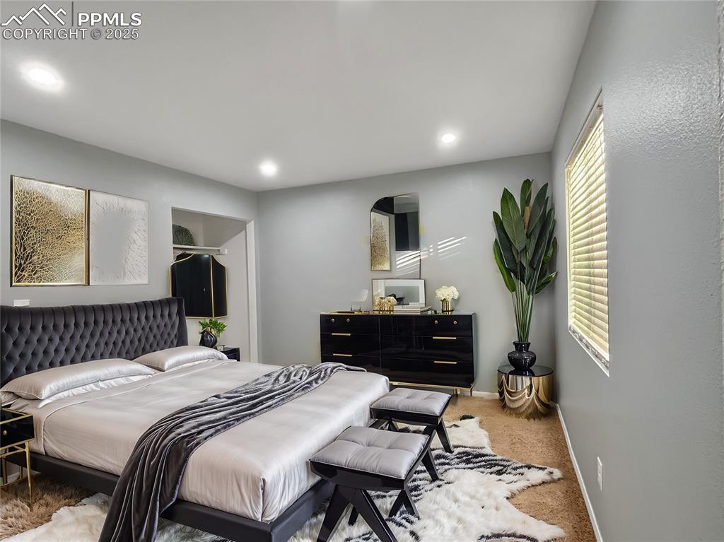 3033 Starlight Circle Colorado Springs, CO 80916 - Photo 25 of 44 a bedroom with a bed and a dresser