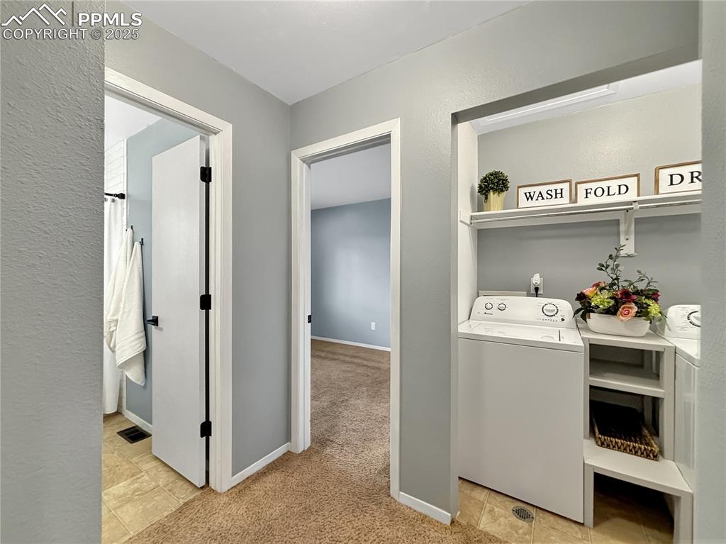 3033 Starlight Circle Colorado Springs, CO 80916 - Photo 30 of 44 a view of utility room with washer and dryer