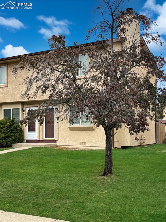3033 Starlight Circle Colorado Springs, CO 80916 - Photo 32 of 44 a front view of a house with garden