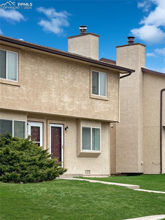 3033 Starlight Circle Colorado Springs, CO 80916 - Photo 33 of 44 a front view of a house with a yard