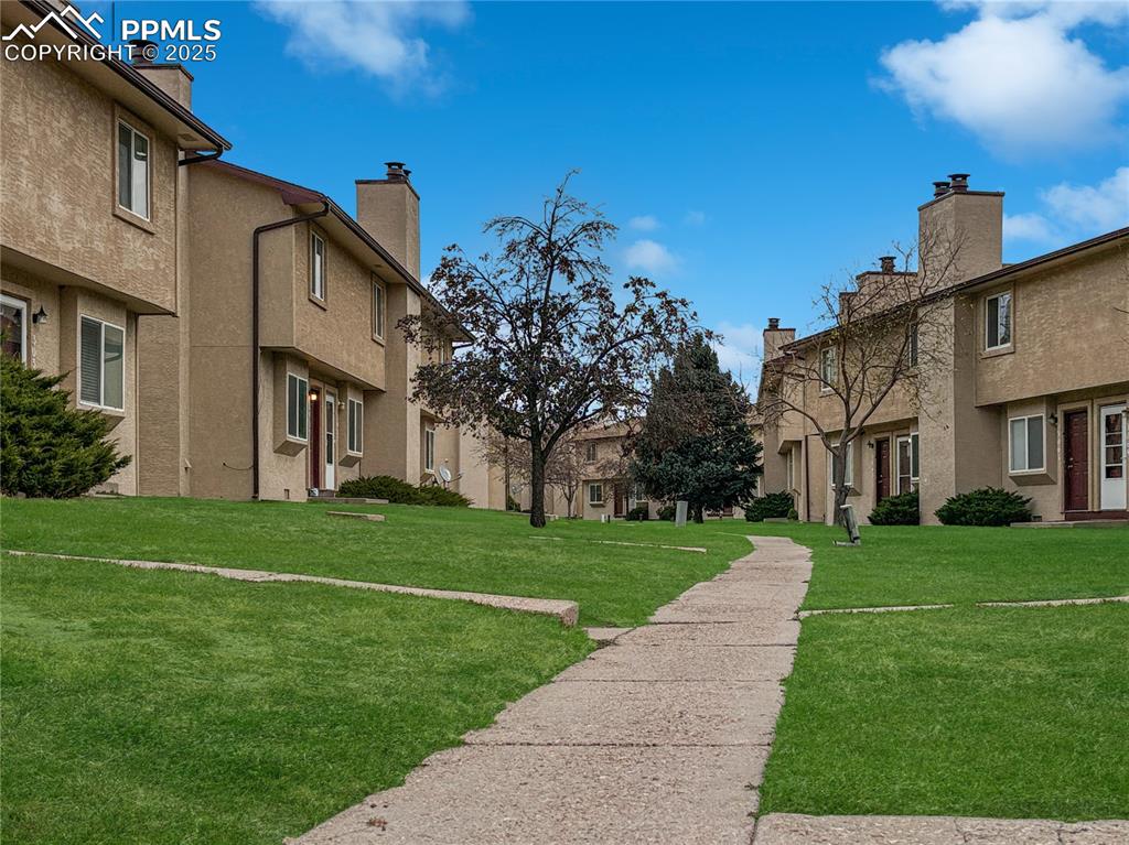 3033 Starlight Circle Colorado Springs, CO 80916 - Photo 39 of 44 a view of a big house with a big yard and large trees