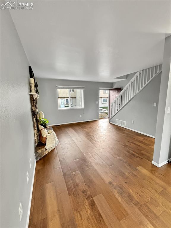 3033 Starlight Circle Colorado Springs, CO 80916 - Photo 6 of 44 a living room with furniture and a wooden floor
