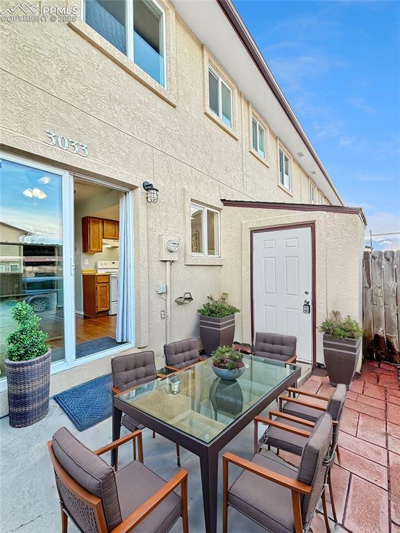 3033 Starlight Circle Colorado Springs, CO 80916 - Photo 9 of 44 a backyard of a house with table and chairs