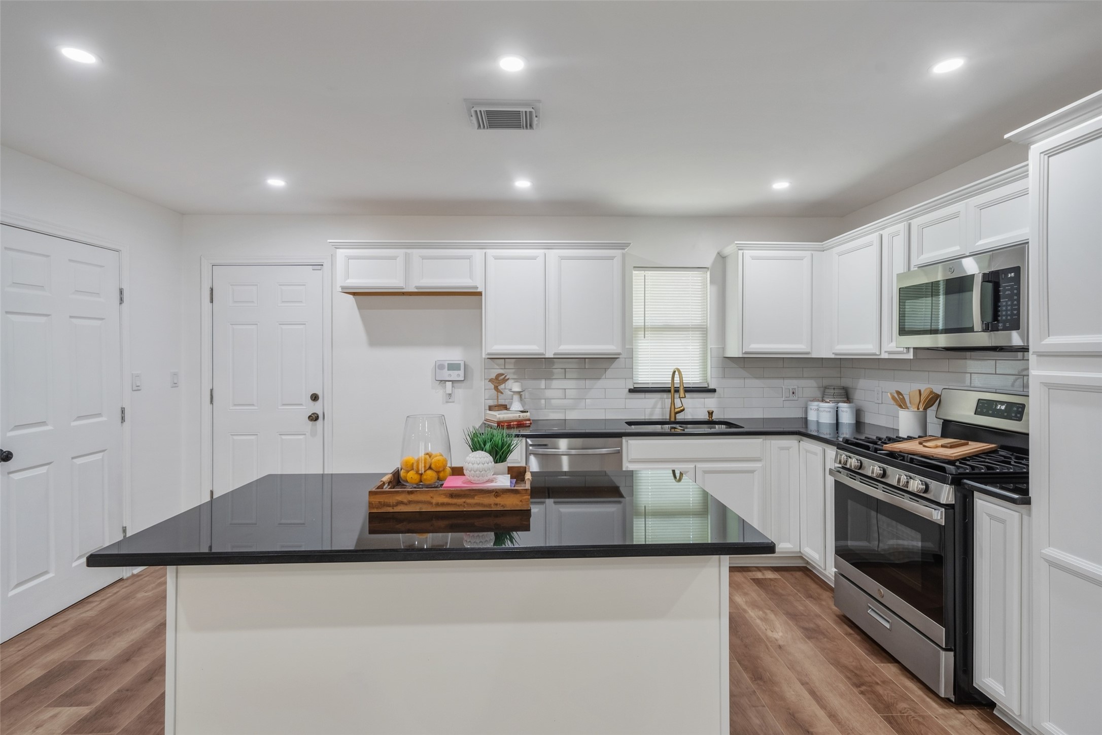 3051 Rothermel Road Houston, TX 77093 - Photo 3 of 24 Sleek kitchen with stainless steel appliances and an island perfect for entertaining.