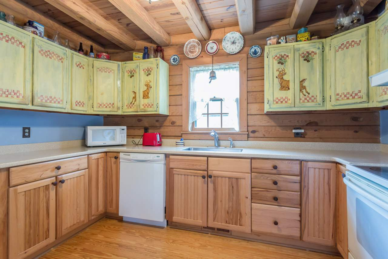 11816 Possum Track Road Raleigh, NC 27614 - Photo 11 of 25 The hand-painted kitchen cabinets offer a whimsical glimpse of country living where deer roam about Hand Painted Kitchen Cabinets