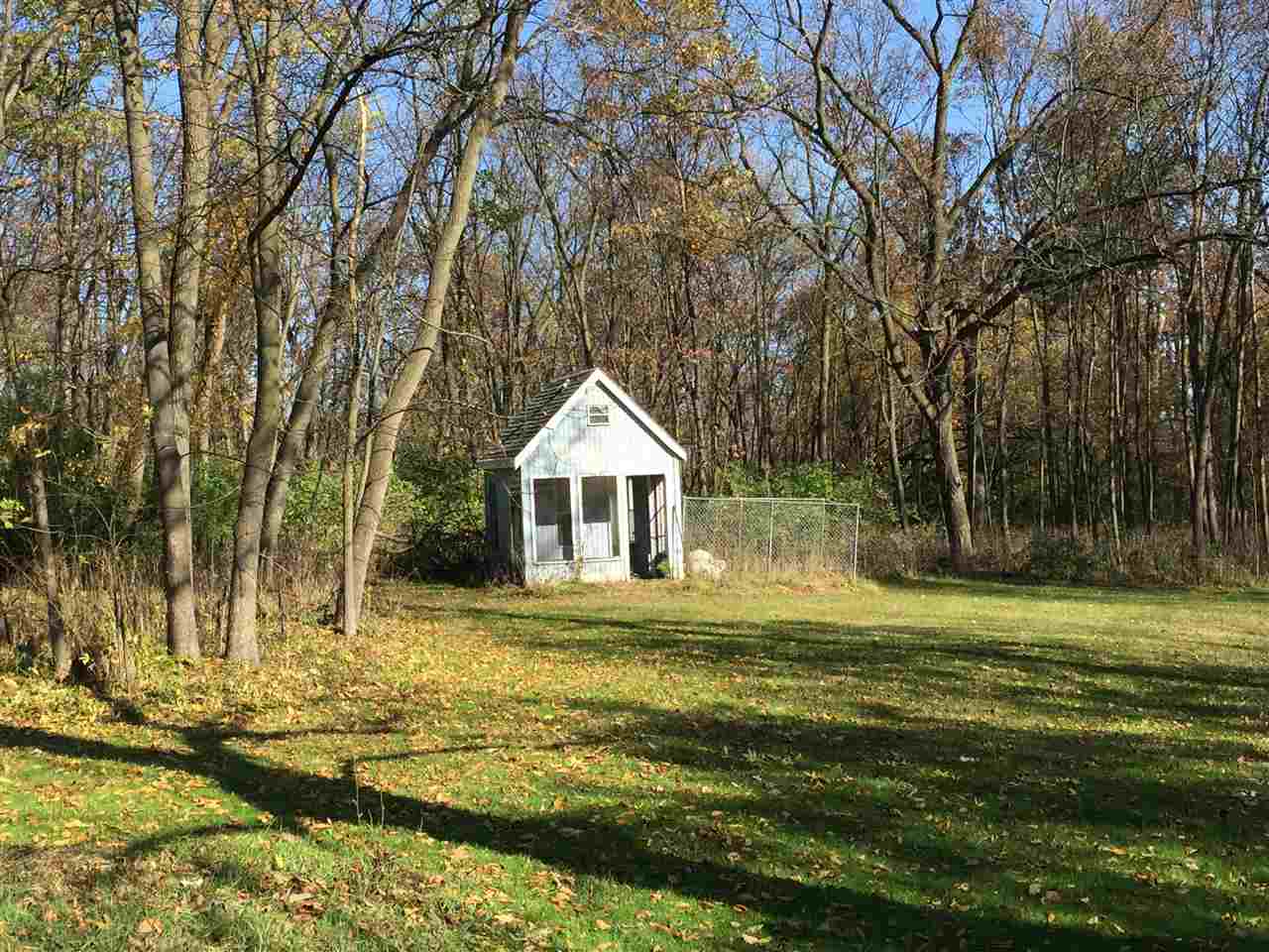 3275 North Meridian Road Stillman Valley, IL 61084 - Photo 5 of 24 a white house with a big yard and large trees