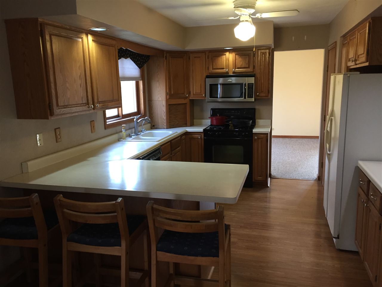 3275 North Meridian Road Stillman Valley, IL 61084 - Photo 10 of 24 a kitchen with kitchen island a sink stove and refrigerator