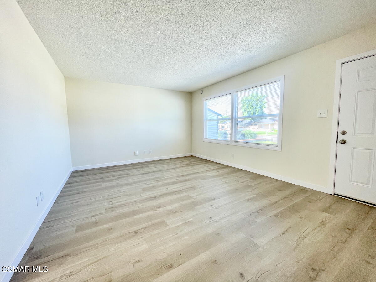 6334 Caroline Avenue Simi Valley, CA 93063 - Photo 6 of 30 an empty room with wooden floor and windows