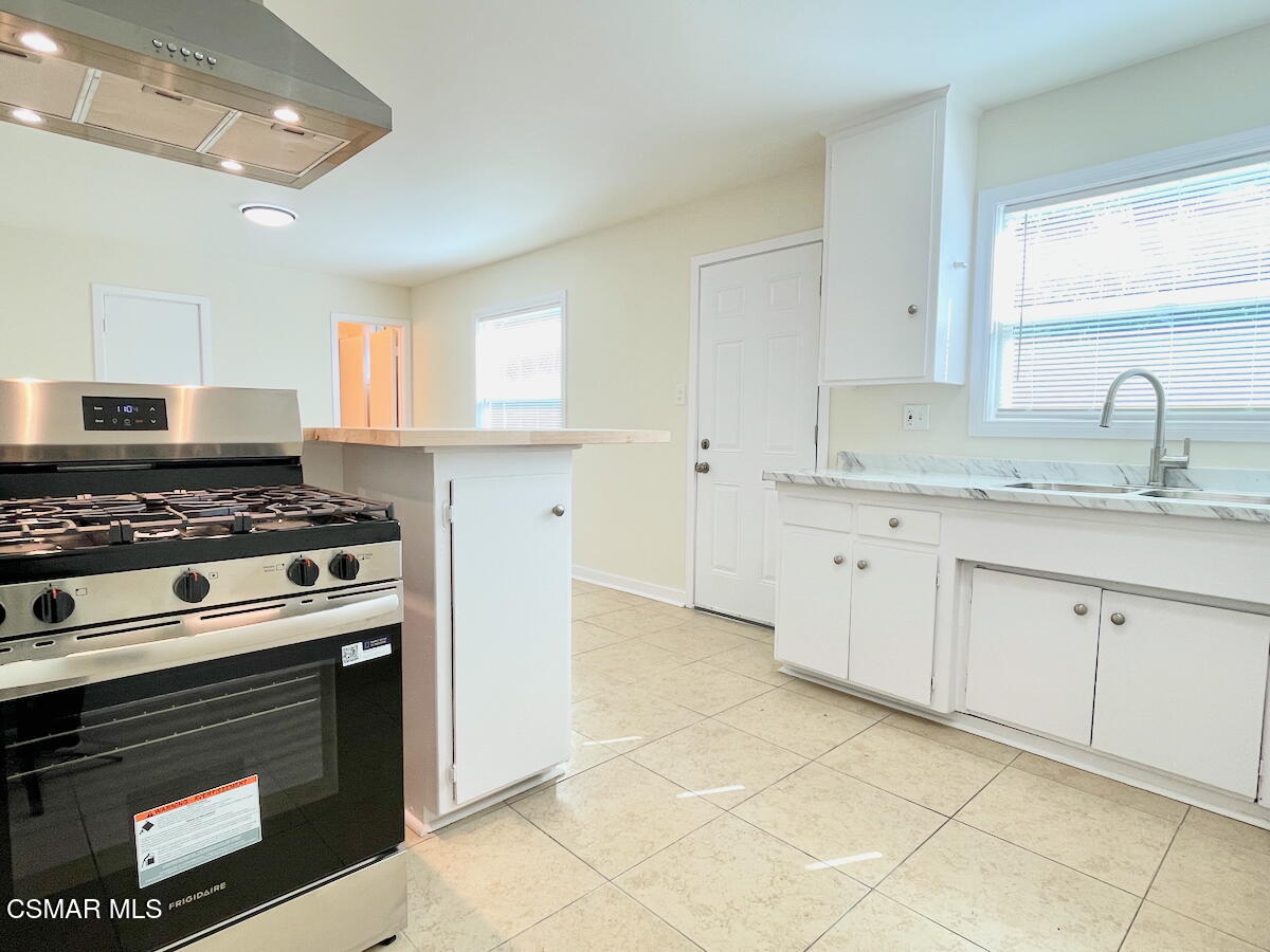 6334 Caroline Avenue Simi Valley, CA 93063 - Photo 10 of 30 a kitchen with cabinets appliances and a window