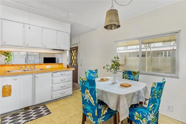 a kitchen that has a table and chairs in it