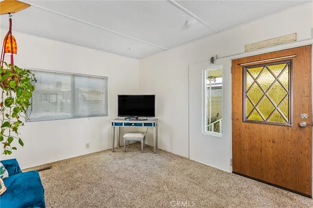 a view of a livingroom with furniture and a window