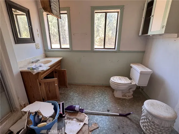 a bathroom with a toilet sink and a mirror